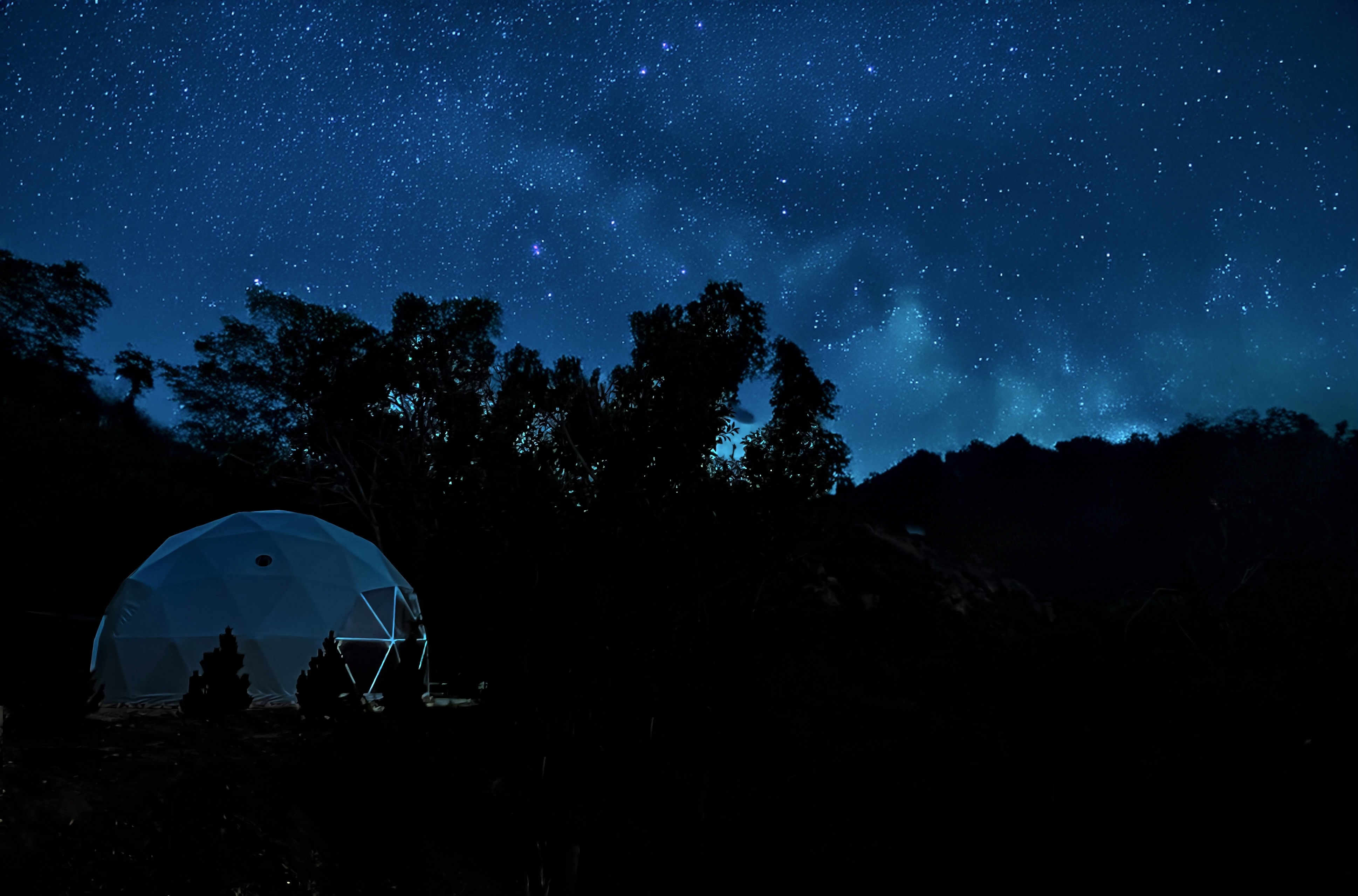 Geodesic dome glowing under a Milky Way sky at Zen Zion