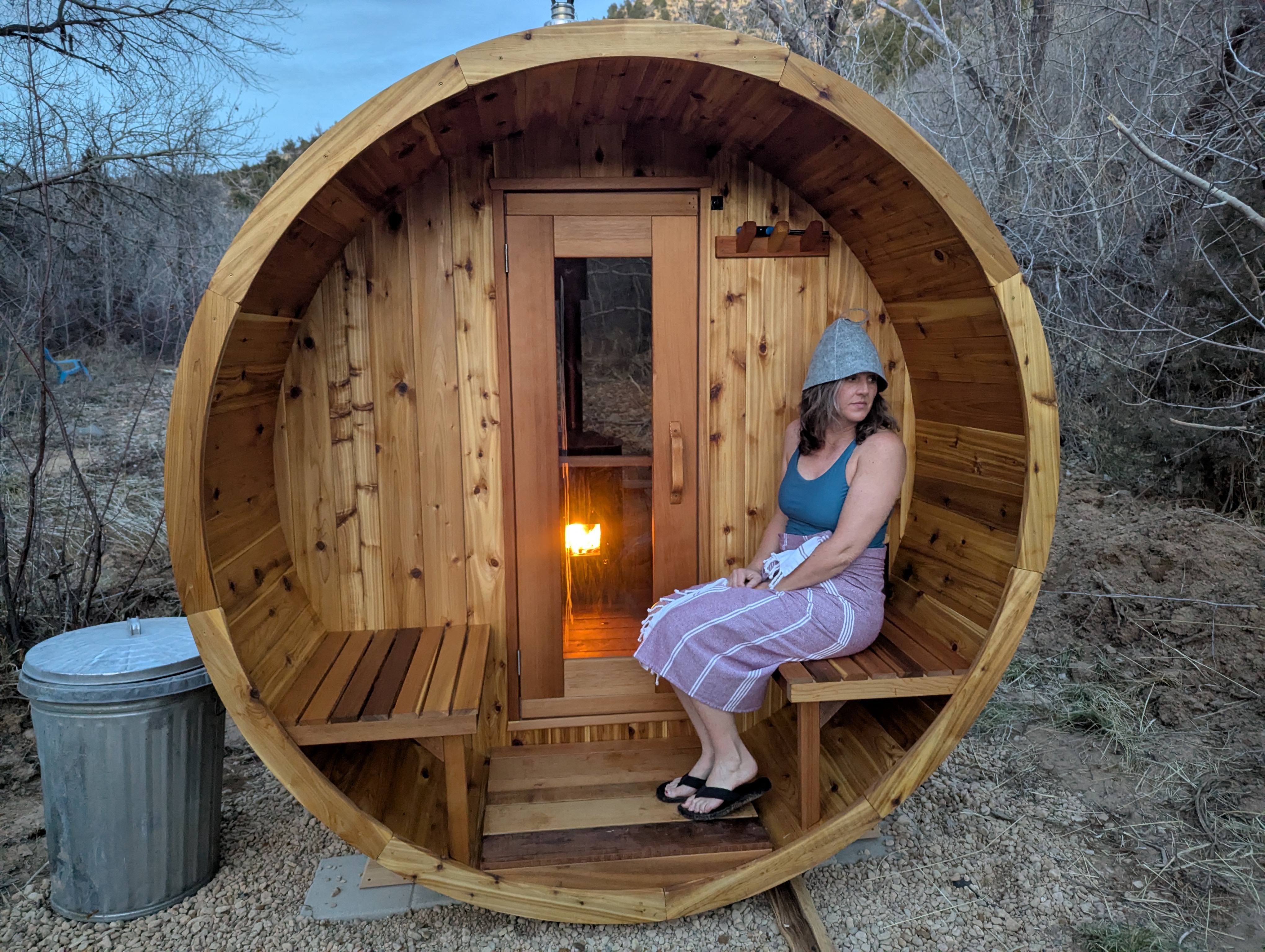 Woman relaxing in cedar barrel sauna at Zen Zion