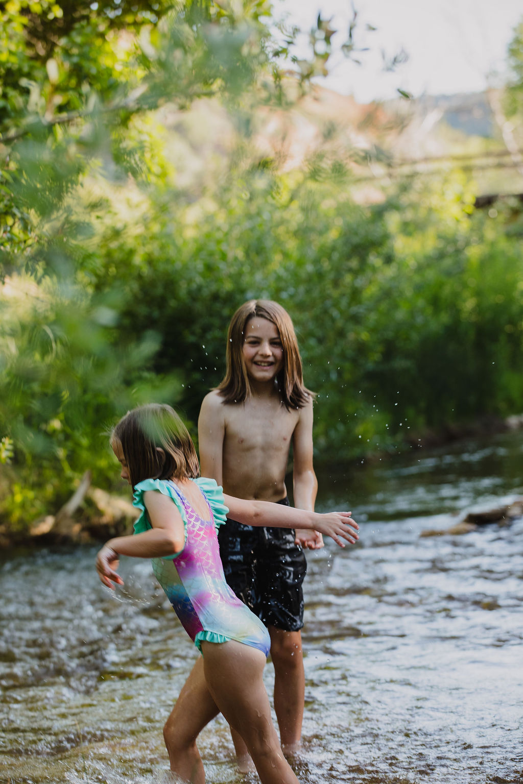 Kids splashing and playing in the private river at Zen Zion